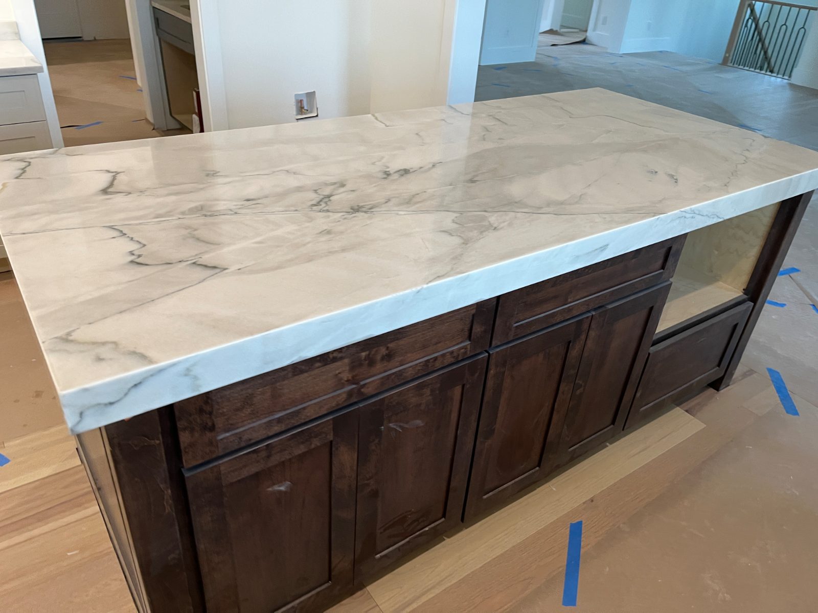 Kitchen countertop installed in Blairsville, GA: Large rectangular island with thick edge over dark shaker cabinets