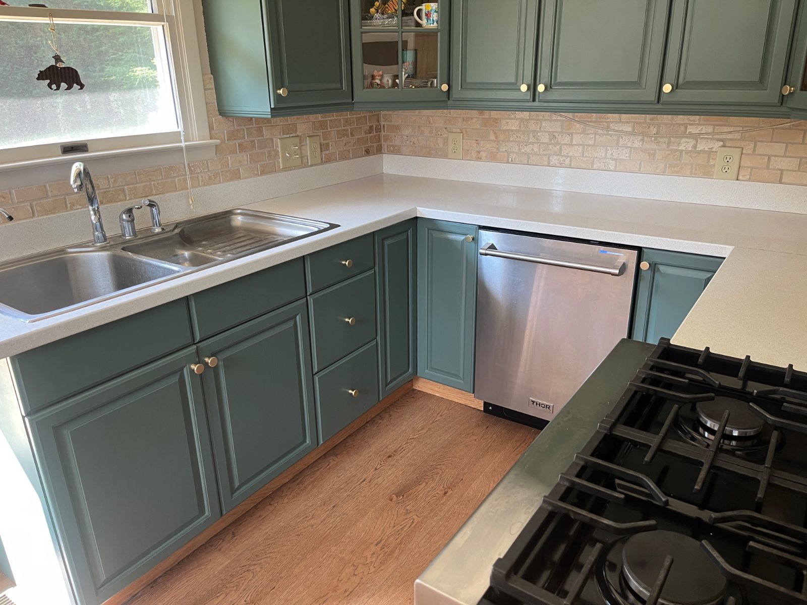 Arctic White kitchen countertop installed in Blairsville, GA: L-shaped kitchen run with a double sink, dishwasher and gas range