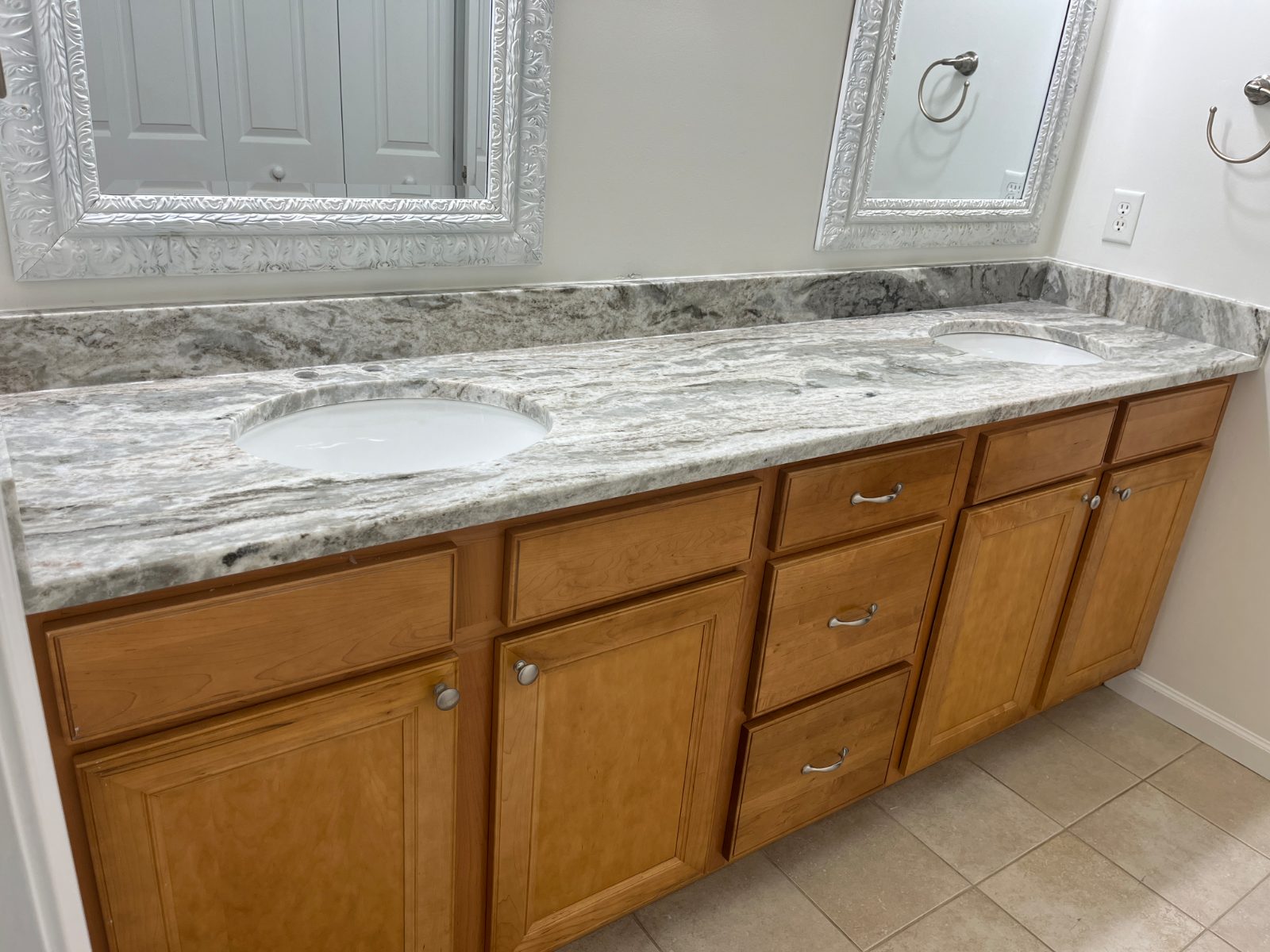 Fantasy Brown bathroom vanity countertop installed in Ellijay, GA: long double vanity with two undermount sinks and a short backsplash