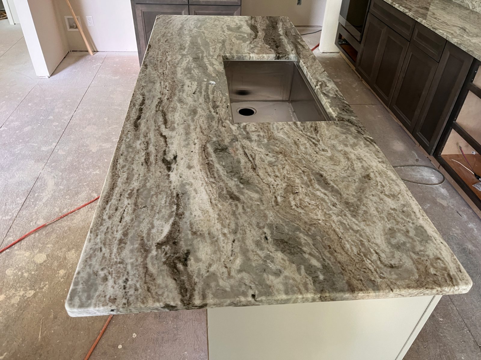 Fantasy Brown kitchen countertop installed in Franklin, NC: kitchen island with a large undermount sink in new construction