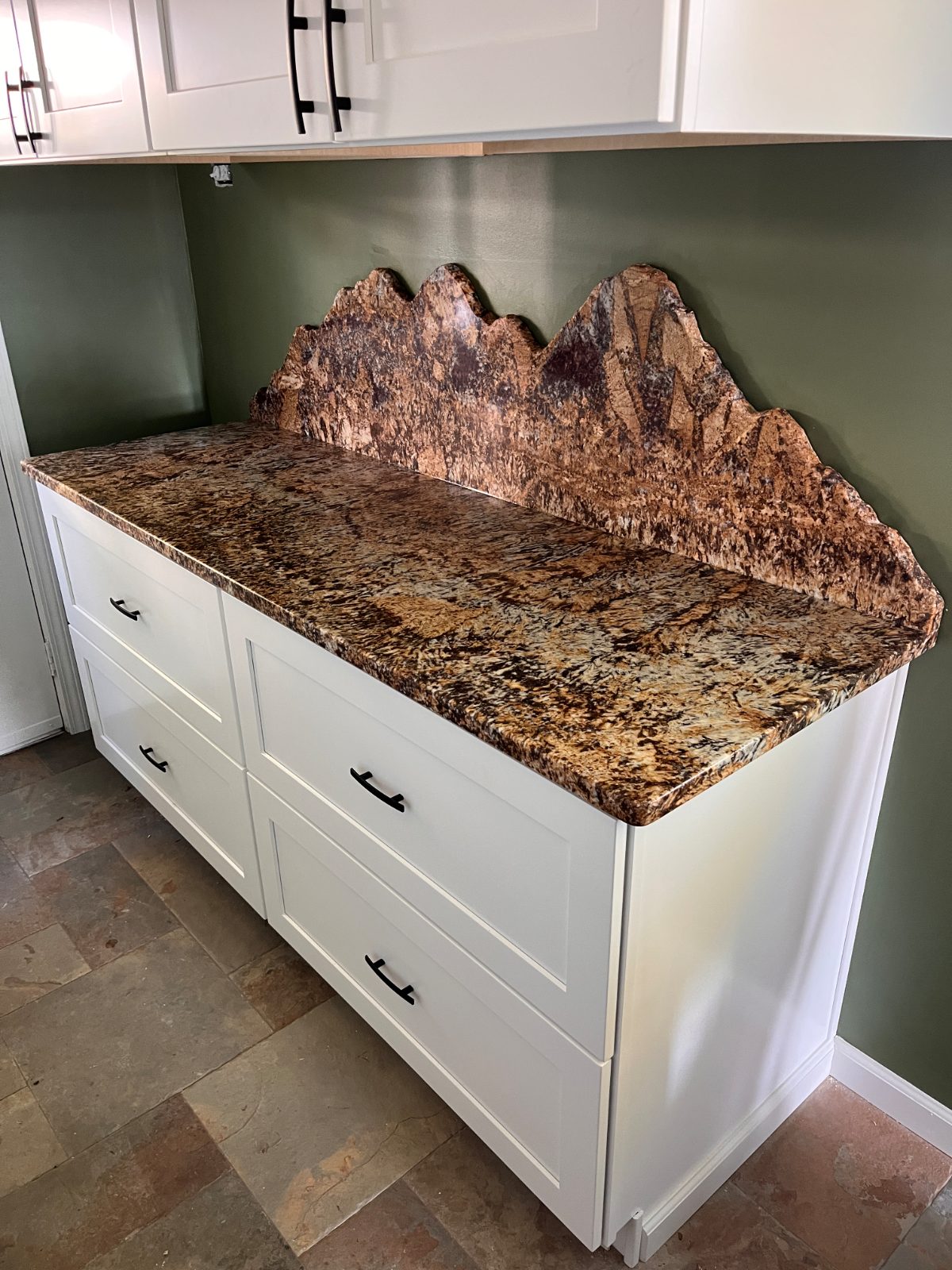 Exotic Yellow countertop installed in Hayesville, NC: Drawer base cabinet run with a tall sculpted backsplash under wall cabinets