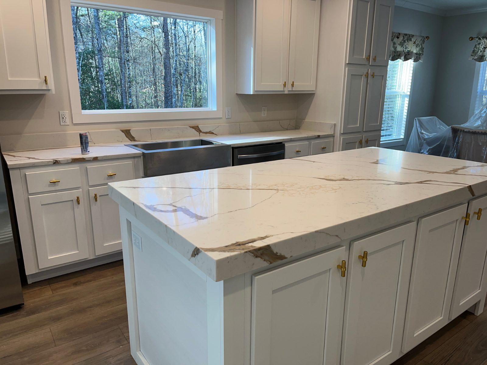 Mocha kitchen countertop installed in Mineral Bluff, GA: Kitchen island and window-wall run with a farmhouse sink