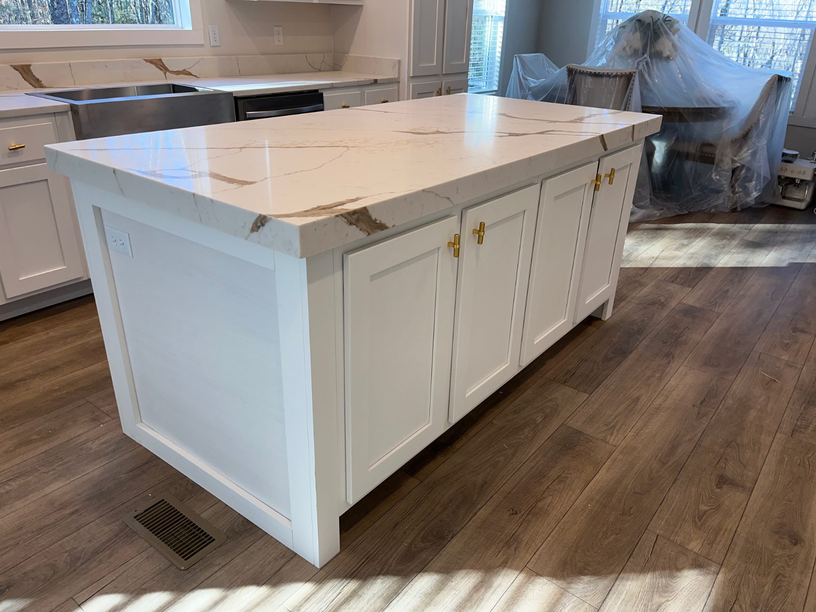 Mocha kitchen countertop installed in Mineral Bluff, GA: Kitchen island end view with a thick edge, sink run behind