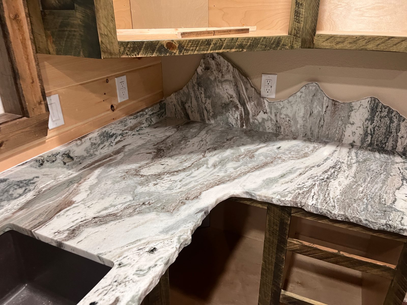 Kitchen countertop installed in Murphy, NC: Corner counter with chiseled edge, mountain-profile backsplash and undermount sink