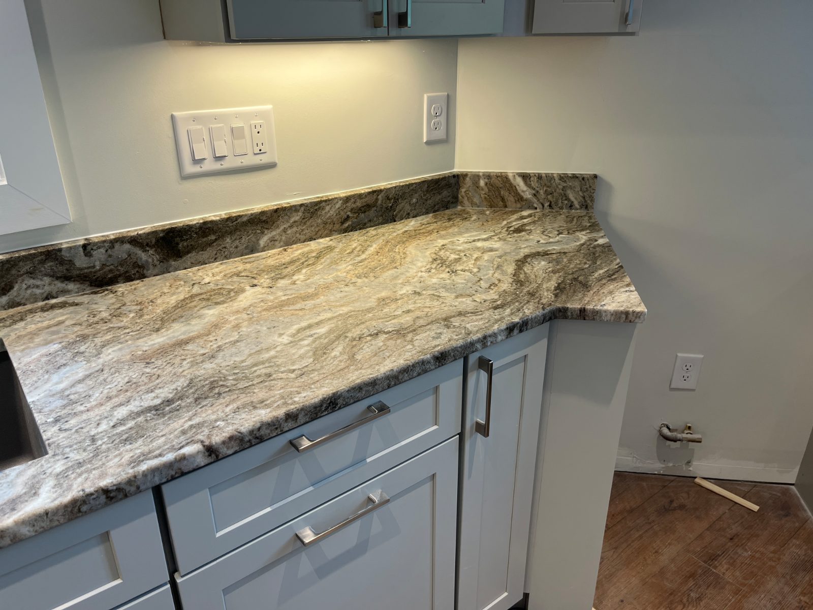 Fantasy Brown, leathered kitchen countertop installed in Murphy, NC: Corner counter run with low backsplash, shaker drawers and sink edge