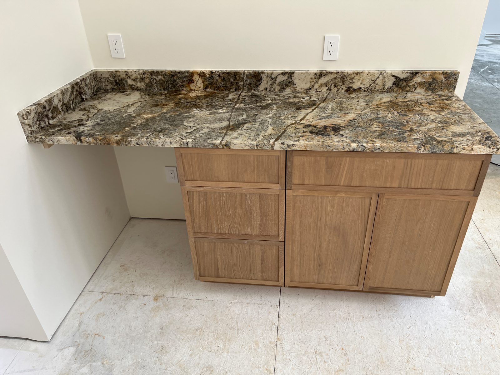 Crazy Horse countertop installed in Murphy, NC: Built-in desk counter with full backsplash and knee space beside cabinets