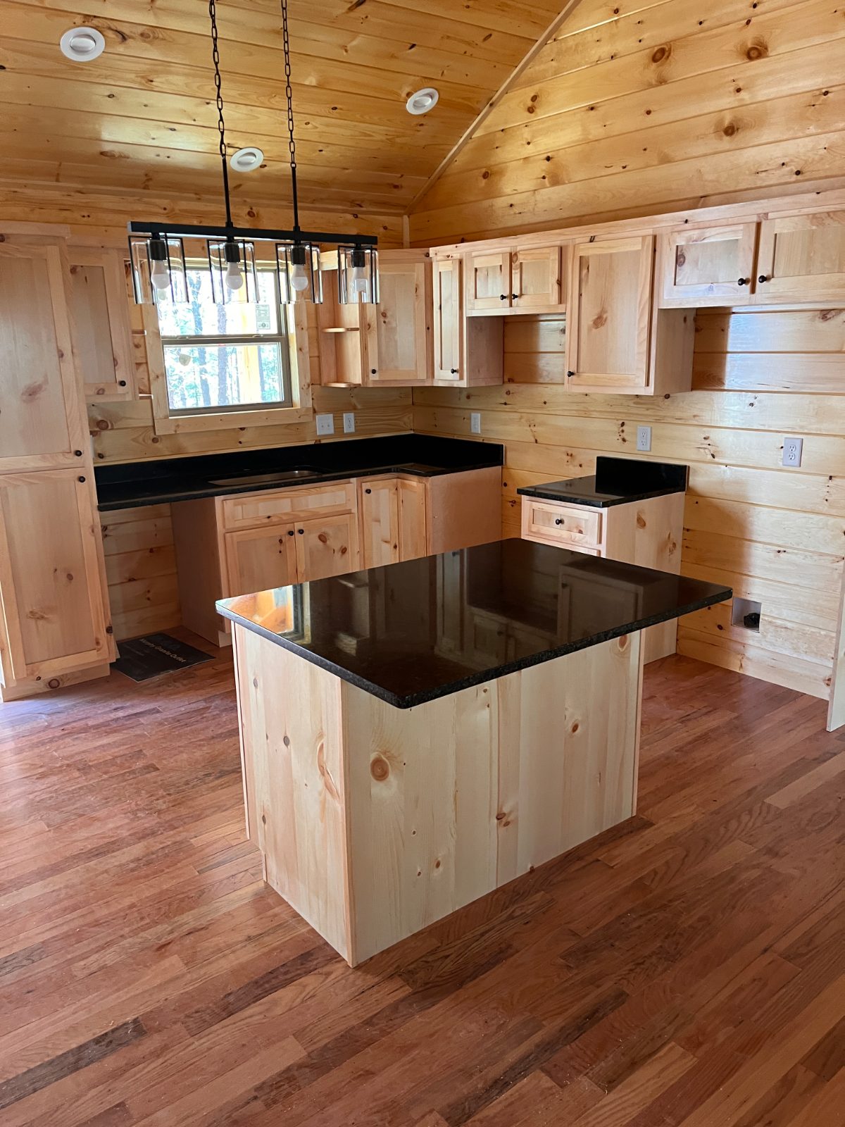 UbaTuba kitchen countertop installed in Murphy, NC: kitchen island with a perimeter sink run and side counter under pendant lights