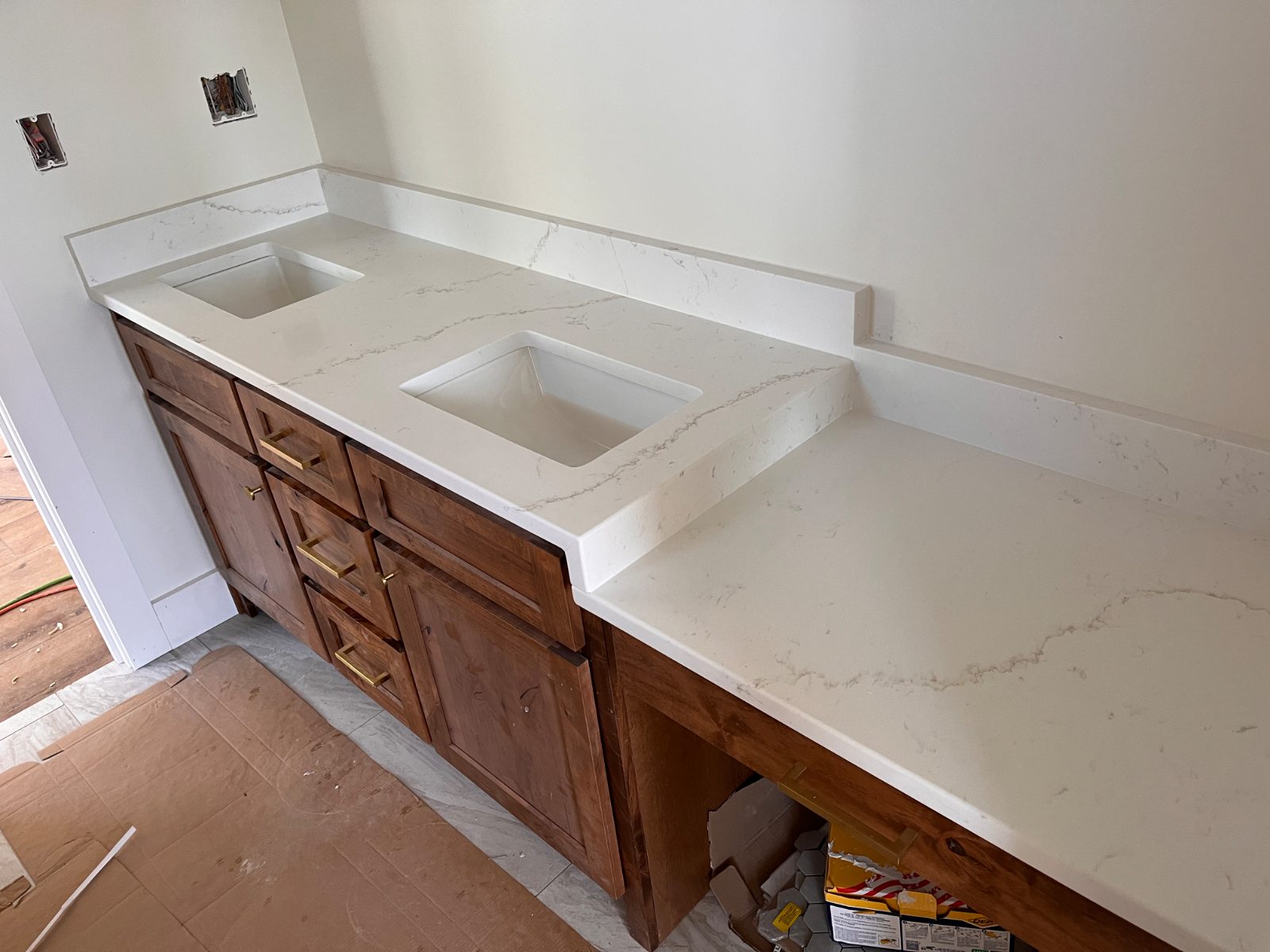 Calacatta Rusta bathroom vanity countertop installed in Turtletown, TN: double vanity with two undermount sinks, backsplash and a knee-space section